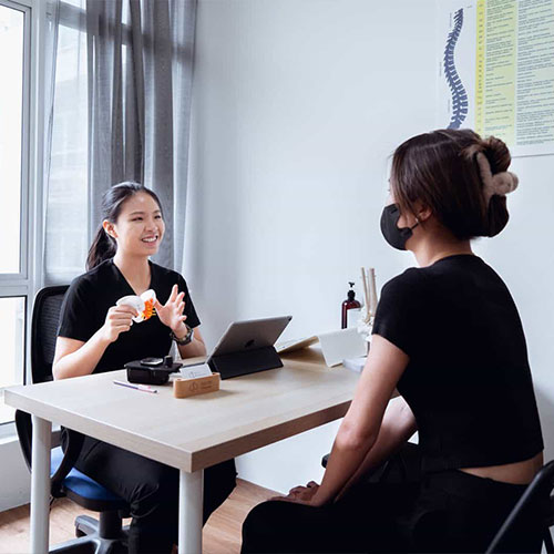 Chiropractor discussing follow-up treatment with a patient